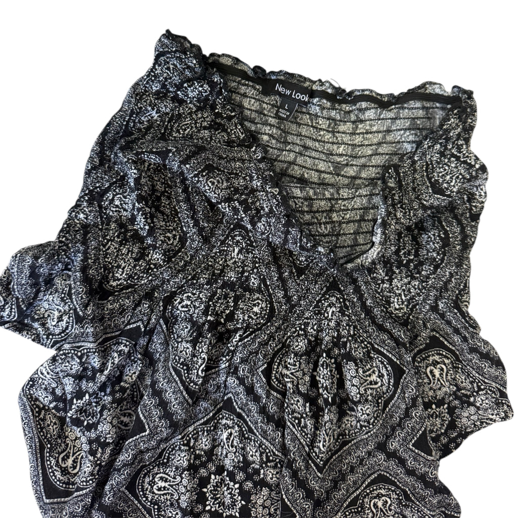 black and white paisley print top with ruffle details
